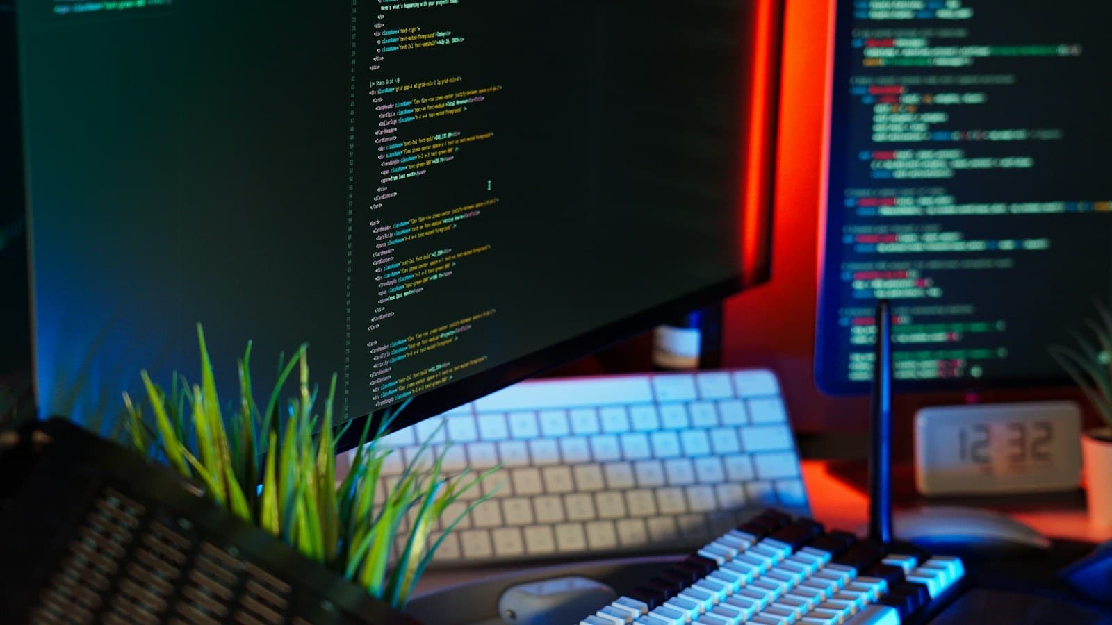 Monitors full of code glowing in a dark room